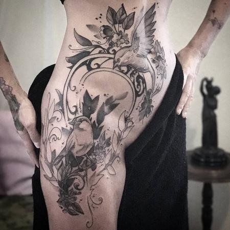 Tattoos - Birds, flowers, vines with Art Nouveau filigree on model's hip. Black and grey.  - 130519